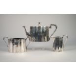 VICTORIAN SILVER TEA SERVICE OF THREE PIECES, OVAL AND LOBED WITH TAPERED STRAIGHT SIDES, foliate