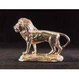 MODERN STERLING SILVER CLAD RESIN MODEL OF A STANDING LION on naturalistic base, 5 1/4" (13.3)