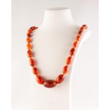 GRADUATED AMBER BEAD NECKLACE, of oval beads knotted to a barrel clasp, length 72cm, 56.85g