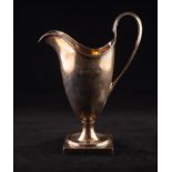 REGENCY STYLE MODERN SILVER HELMET SHAPED CREAM JUG, with reeded high loop handle and square base,