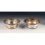 PAIR OF SILVER PLATED ON COPPER WINE BOTTLE COASTERS, each of typical form with gadrooned border and
