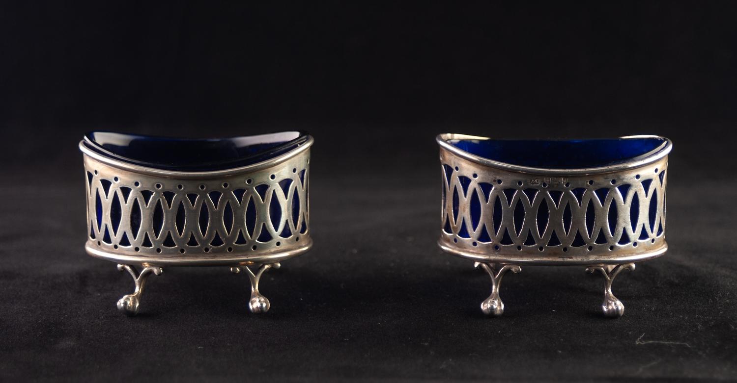 A PAIR OF EDWARDIAN OVAL SILVER SALT CELLARS, with blue glass liners, each standing on four claw and - Image 2 of 2