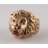 9ct GOLD RUBY LION HEAD RING. Cast as a lion head with a round ruby in the mouth, ring size P1/2,
