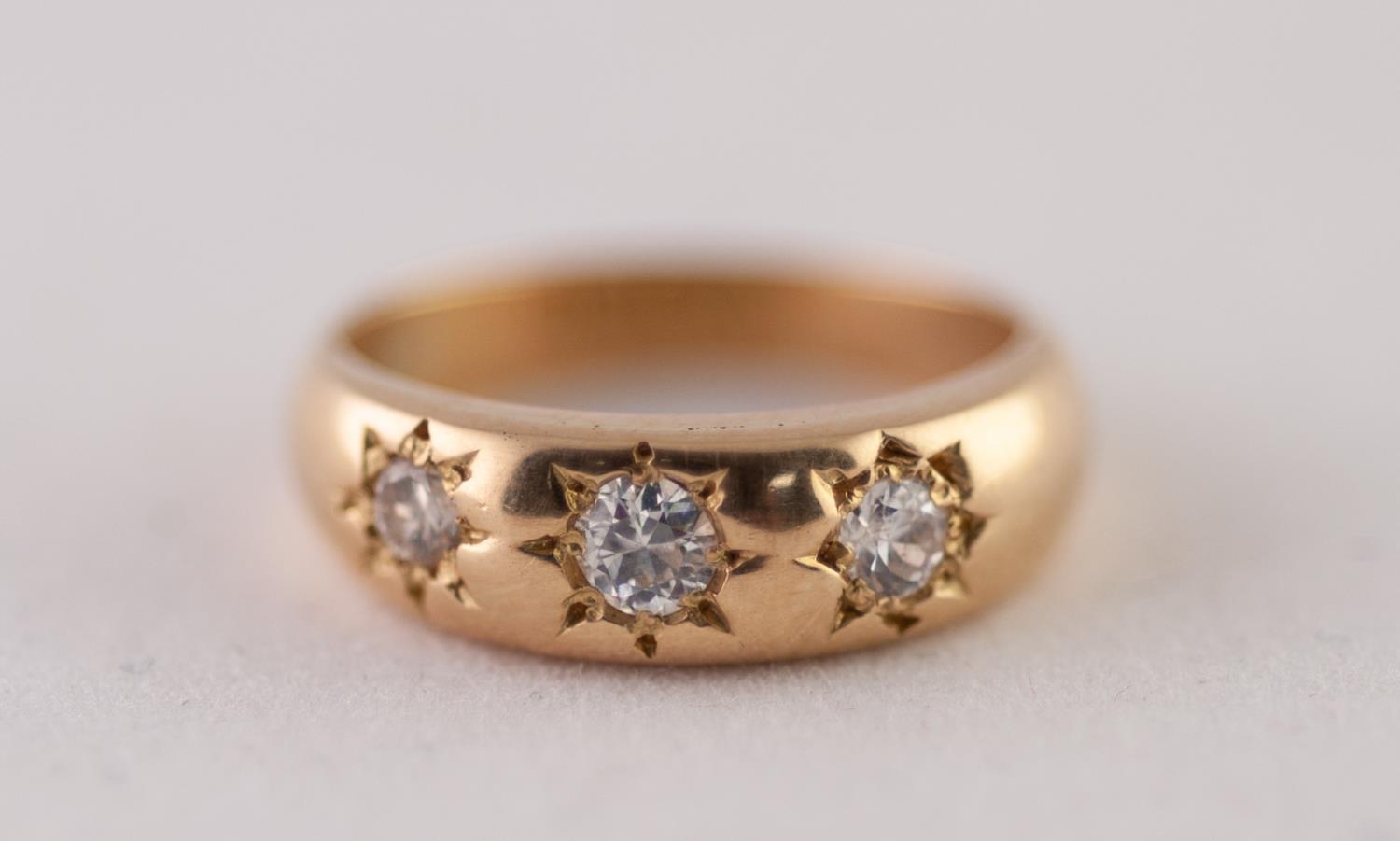 18ct GOLD DIAMOND THREE STONE RING. Star set graduated old cut diamonds, to a tapered shank, total