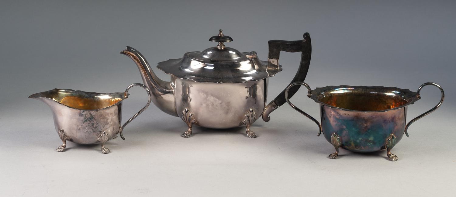 THREE PIECE ELECTROPLATED TEA SET, of oval form with cyma borders, angular scroll handles and scroll