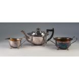 THREE PIECE ELECTROPLATED TEA SET, of oval form with cyma borders, angular scroll handles and scroll