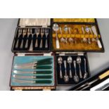 A CASED SET OF CARVING IMPLEMENTS, and FIVE VARIOUS CASED SETS AND PART SETS of plated teaspoons,