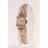LADY'S AVIA 9ct GOLD WRIST WATCH, with mechanical movement, small square silvered Arabic dial, small