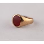 CARNELIAN SIGNET RING. Oval carnelian in a rubbed over setting, to a tapered shank, stamped '9CT',