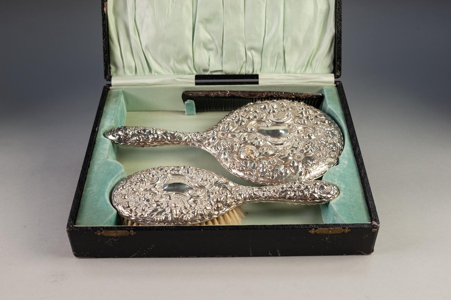 GEORGE V CASED THREE PIECE EMBOSSED SILVER BACKED DRESSING TABLE HAND MIRROR AND BRUSH SET, repousse - Image 2 of 2