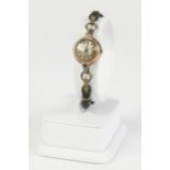 LADY'S GOLD CASED WRIST WATCH, mechanical movement, small circular silvered dial, with batons, on