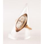 9ct GOLD DRESS RING COLLET SET WITH AN OVAL CITRINE, with a marquise shaped surround, 4.5gms