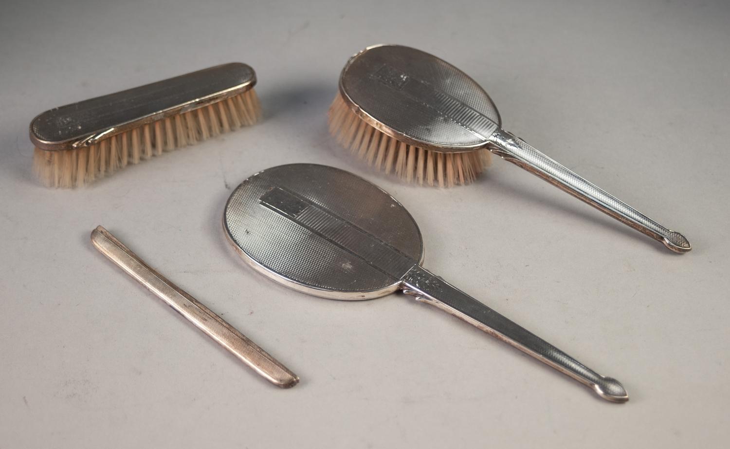 A MODERN ENGINE TURNED SILVER PART DRESSING TABLE BRUSH SET viz HAND MIRROR, HAIR BRUSH AND