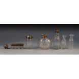 GEORGE V SILVER MOUNTED CUT GLASS PERFUME BOTTLE, of orbicular form with flat hinged cover,