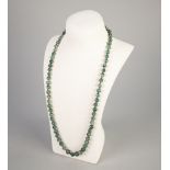 SINGLE STRAND NECKLACE OF GRADUATED MOSS AGATE ROUND BEADS, threaded on a knotted cordm with