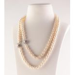TWO SINGLE STRAND NECKLACES OF UNIFORM IMITATIONS PEARLS, with matching silver clasps, 40" long is