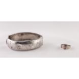 SILVER HINGE OPENING HOLLOW BROAD BANGLE, with engraved top, Birmingham 1966 AND A CHASED SILVER