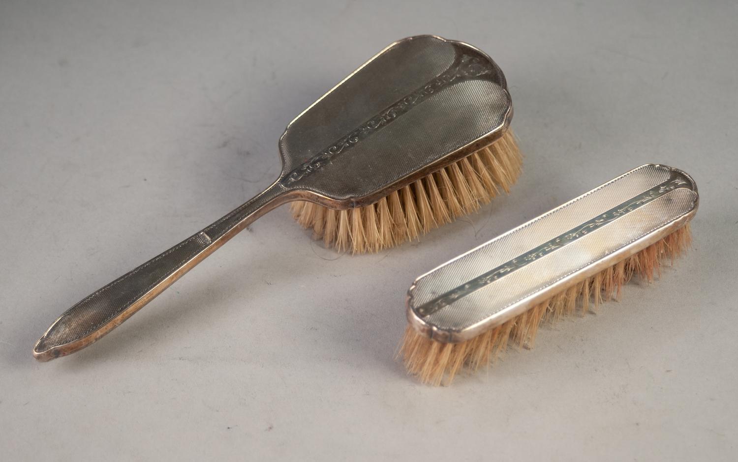 A POST WAR ENGINE TURNED SILVER BACKED HAIR BRUSHES AND MATCHING CLOTHES BRUSH