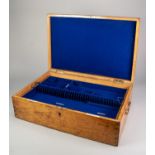 AN OAK CANTEEN LINED WITH ROYAL BLUE VELOUR with a removable tray, inset with bone tablets inscribed