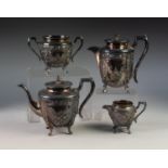 FOUR PIECE EMBOSSED ELECTROPLATED TEA SET, of slightly tapering form with angular scroll handles and