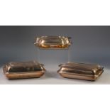 THREE ELCTROPLATED ENTREE DISHES WITH TWO HANDLED COVERS, of rounded oblong form, one with nulled