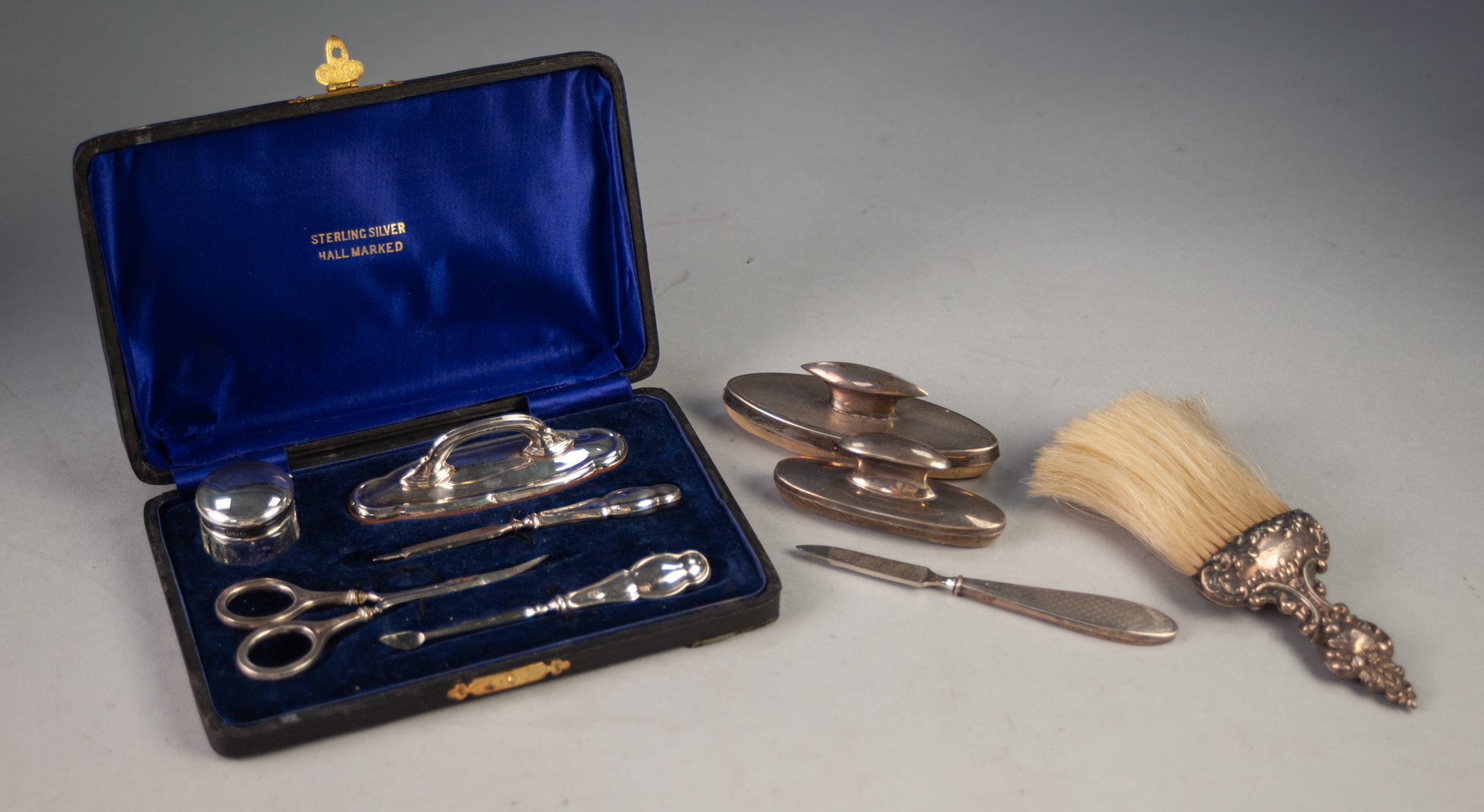 COMPOSITE SILVER MANICURE SET having four matching pieces including nail buffer and silver lidded