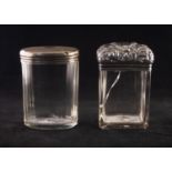 A LATE VICTORIAN SILVER TOPPED RECTANGULAR DRESSING TABLE JAR, well chased with foliate scrollwork