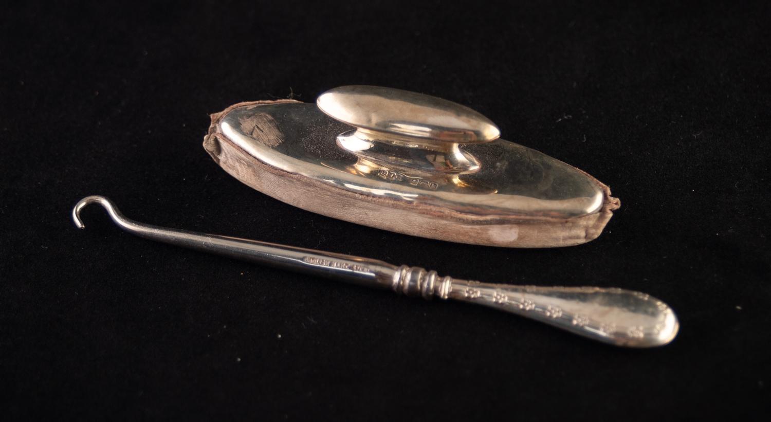 A SILVER TOPPED MANICURING NAIL BUFFER, also a SILVER HANDLED STEEL BUTTON HOOK (2)
