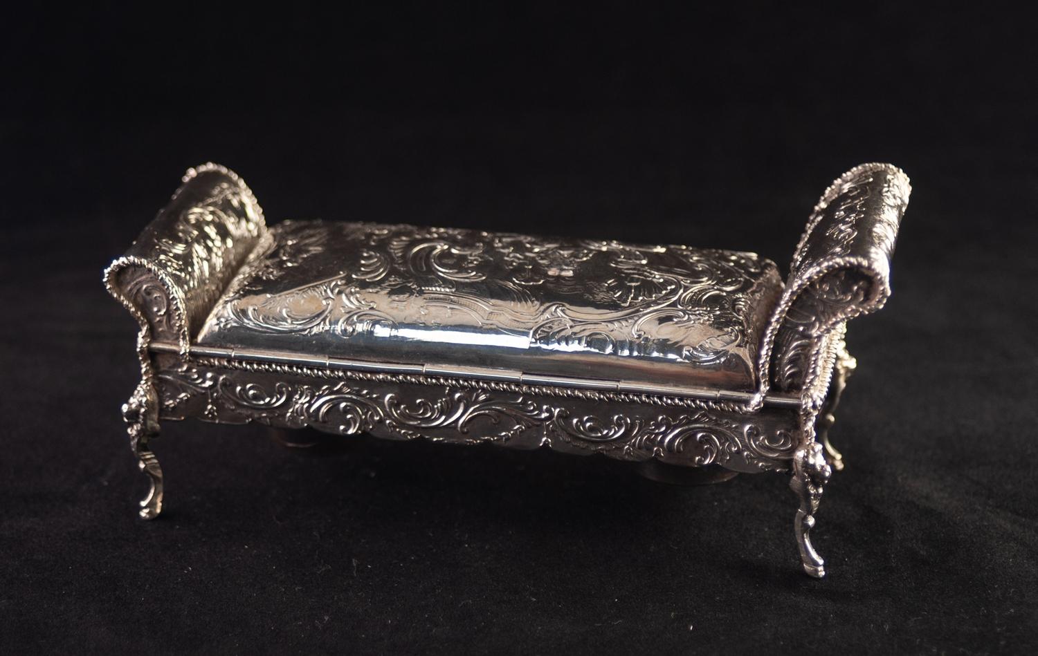 A LATE NINETEENTH CENTURY CONTINENTAL SILVER INKSTAND in the form of scroll ended stool, stamped