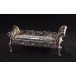A LATE NINETEENTH CENTURY CONTINENTAL SILVER INKSTAND in the form of scroll ended stool, stamped