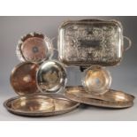 ELECTROPLATED TWO HANDLED ROUNDED OBLONG TRAY, with scrollengraved centre and floral capped