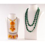 TWO METAL CHAIN NECKLACES with attached butterscotch amber pendant fruits a malachite continuous