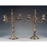 IMPRESSIVE PAIR OF FIVE LIGHT ELECTROPLATED TWO PIECE CANDELABRA, each with four scroll arms and