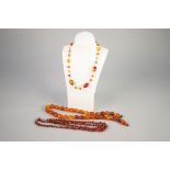 THREE SIMULATED AMBER BEAD NECKLACES, including one of oval beads, length 63cm
