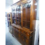 A MODERN REPRODUCTION MAHOGANY BOOKCASE, WITH ASTRAGAL GLASS UPPER SECTION, DRAWERS AND CUPBOARDS