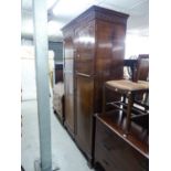 AN EDWARDIAN MAHOGANY TWO DOOR WARDROBE/CUPBOARD, ON PLINTH BASE