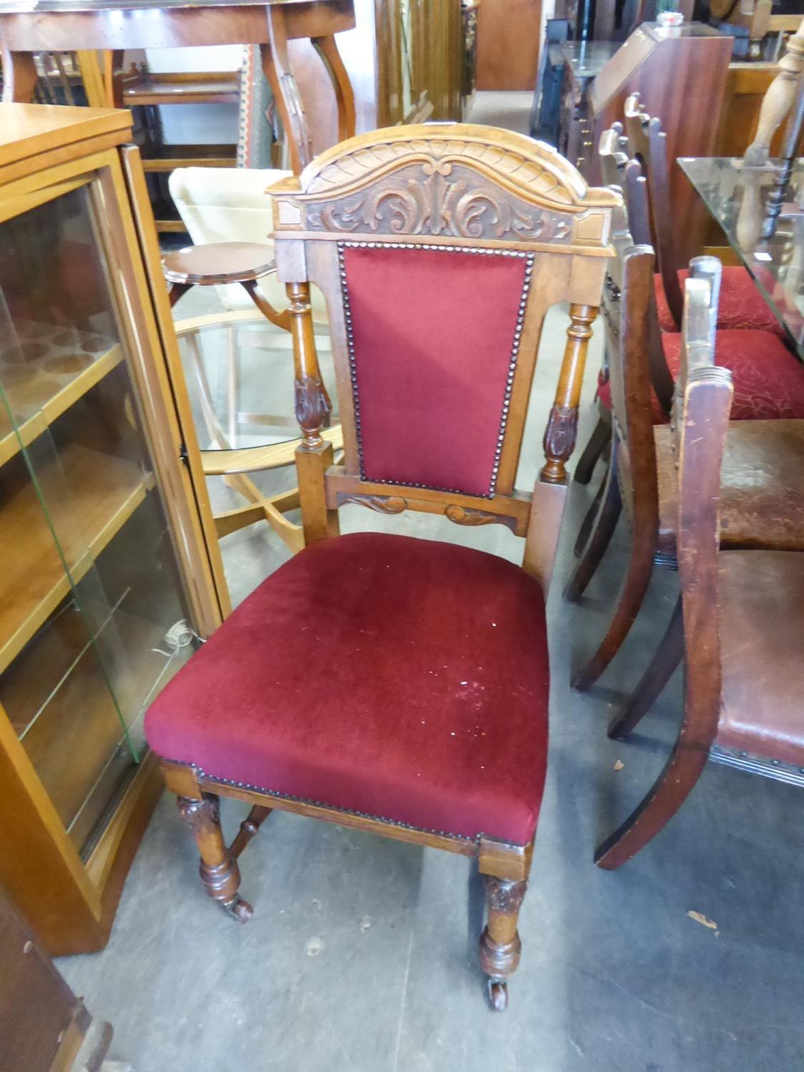 LATE VICTORIAN CARVED OAK SINGLE CHAIR WITH UPHOLSTERED BACK PANEL AND SEAT COVERED WITH RED