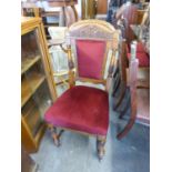 LATE VICTORIAN CARVED OAK SINGLE CHAIR WITH UPHOLSTERED BACK PANEL AND SEAT COVERED WITH RED