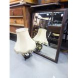 A wrought iron table lamp frame with glass insert, and an oak framed wall mirror (2)