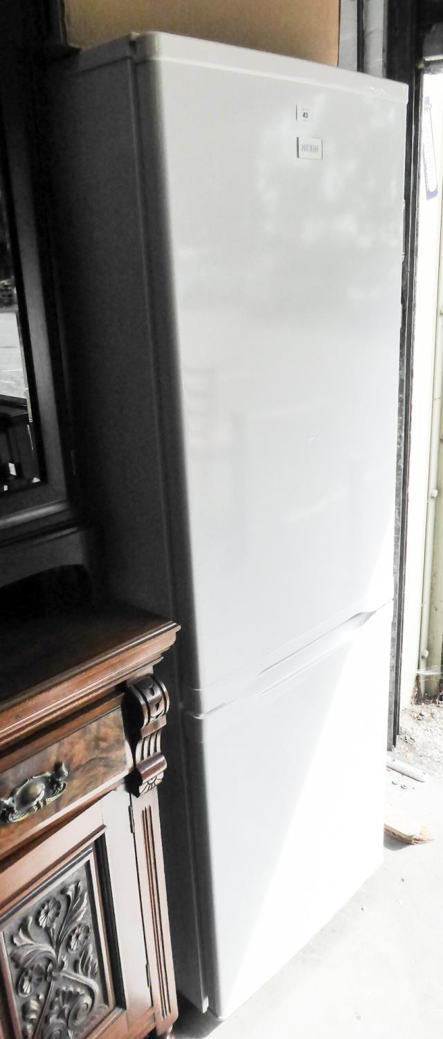 AN OAK SECRETAIRE WITH BOOKCASE SECTION ABOVE AN UPRIGHT FALL-FRONT WRITING SECTION OVER A