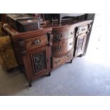 LATE VICTORIAN CARVED AND FIGURED WALNUT WOOD SIDEBOARD WITH LEDGE BACK, BOW FRONTED TO COMBI