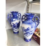 PAIR OF BLUE GLAZED TWO HANDLE VASES WITH FLORAL DEOCORATION, 13 1/2" (34.2cm) TALL