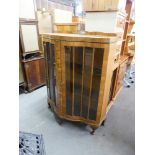 A BOW FRONTED WALNUTWOOD DISPLAY CABINET