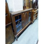 MAHOGANY SMALL DISPLAY CABINET WITH LEDGE BACK, CENTRE PANEL DOOR, FLANKED BY GLAZED PANEL DOORS,