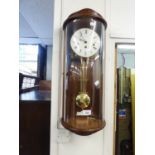 MODERN 'HERMLE' WALL CLOCK WITH CURVED GLASS DOOR AND PENDULUM