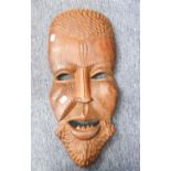 AN AFRICAN ABORIGINAL CARVED WOODEN MASK, MAN WITH LOWER FANGS