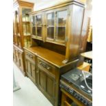 OAK DRESSER WITH TWO DRAWERS OVER TWO CUPBOARD DOORS, THE RAISED BACK WITH TWO GLAZED DOORS OVER