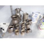 ?A SMALL SELECTION OF PEWTER MEASURES ALSO A TANKARD WITH A HINGED BEER MUG, INSCRIBED WITH