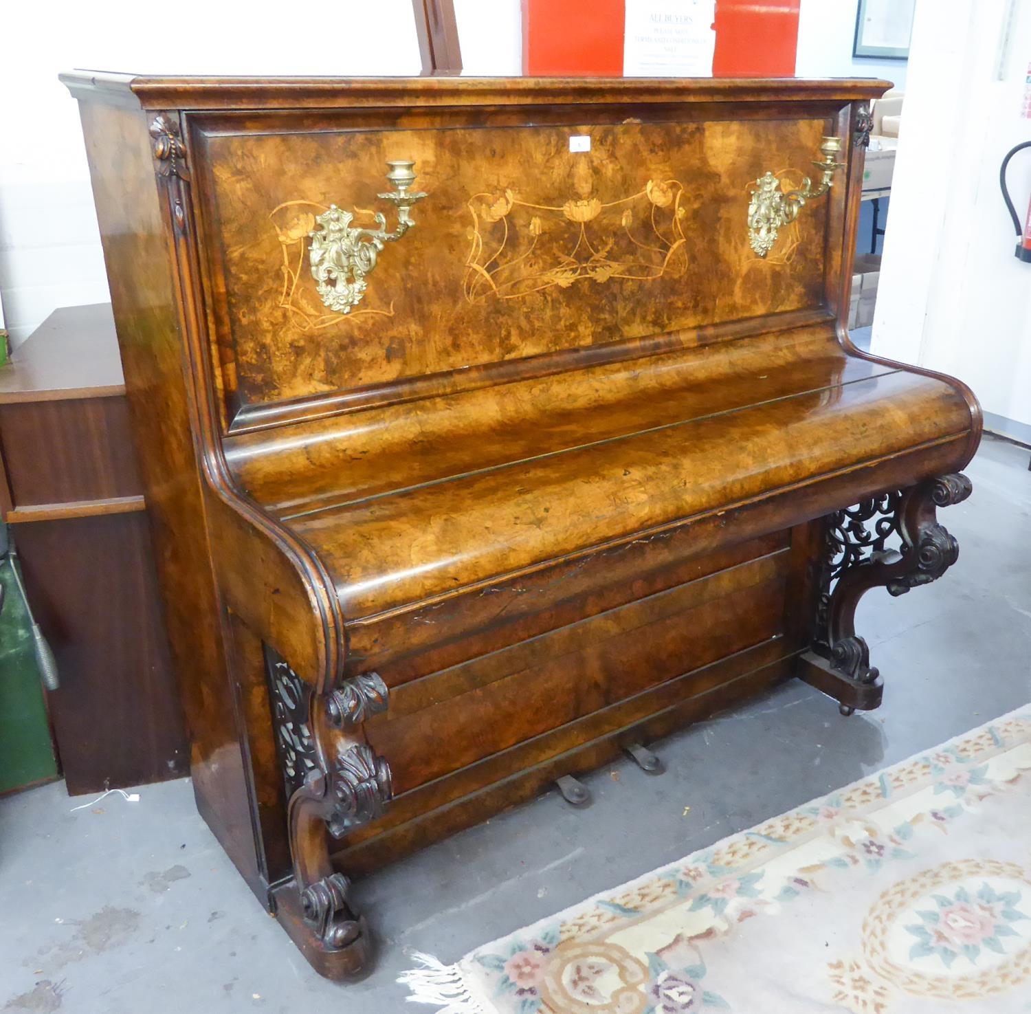 ?BURR WALNUT INLAID UPRIGHT PIANO WITH A PAIR OF BRASS SCONCES AND VERY ATTRACTIVE CARVED FRONT