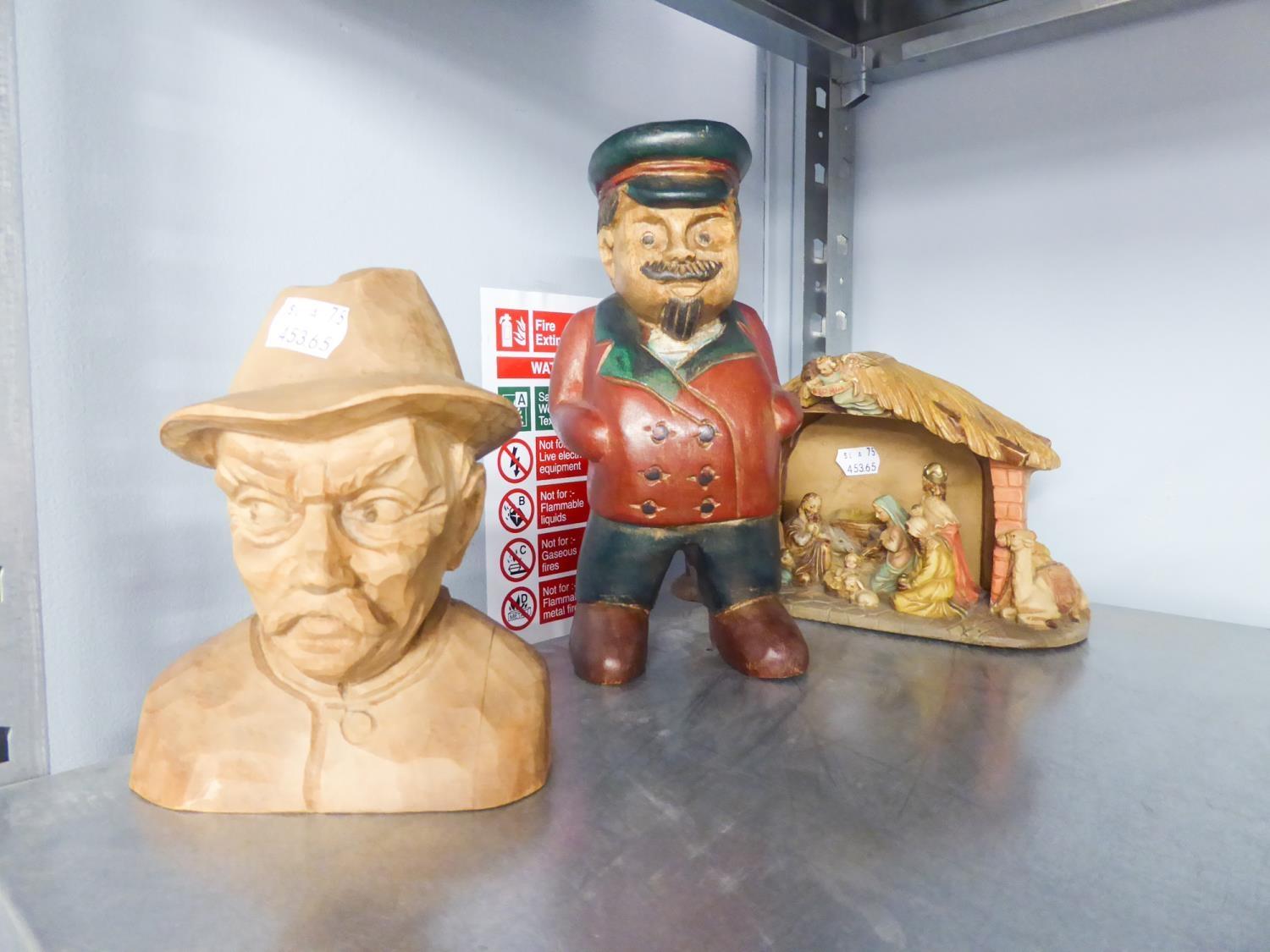 A CARVED WOODEN NATIVITY, A CARVED AND PAINTED WOOD FIGURE OF LENIN AND A PLAIN CARVED SOFT WOOD